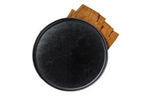 Table setting with vintage empty black plate on rustic wood. Isolated, white background. photo