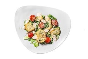 Caesar salad with grilled chicken, croutons, quail eggs and cherry tomatoes. Isolated on white background. Top view. photo