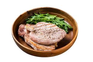 Roasted pork chop steaks or cutlets with arugula salad. Isolated on white background. Top view. photo