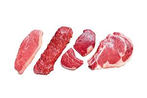Raw prime black angus beef steaks fillet Mignon, rib eye or cowboy, Striploin or new york, skirt or machete. Isolated on white background. Top view. photo