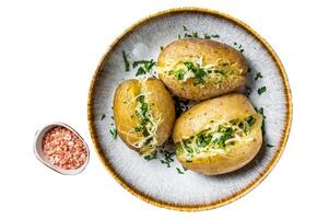 Baked Jacket potatoes with cheese and butter. Isolated, white background. photo