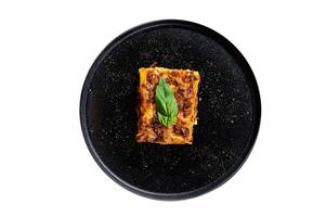 Homemade Italian Lasagna with Tomato Sauce and Beef. Isolated on white background. photo