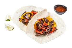 Fajitas with beef meat stripes, colored bell pepper and onions, served with tortillas and salsa. Isolated on white background, Top view. photo