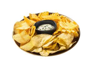 Variety of Potato chips in a plate served with dip sauce. Isolated on white background. photo