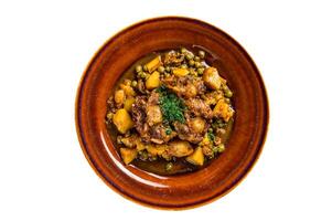 Beef veal oxtails stew with vegetables in a rustic plate. Isolated on white background. photo