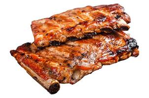 Stack of grilled pork ribs in BBQ sauce on a chopping board. Isolated, white background. photo