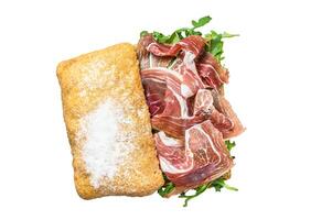 Prosciutto parma ham sandwich on ciabatta bread with arugula. Isolated on white background. photo