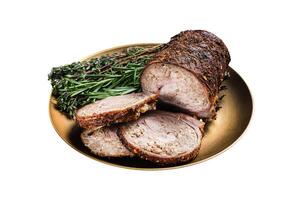 Slices of roasted stuffed pork meat roulade on a plate with rosemary and thyme. Dark background. Top view photo