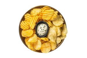 Variety of Potato chips in a plate served with dip sauce. Isolated on white background photo