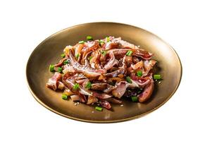 Asian appetizer pig pork ears with sesame seeds, green onion and spicy sauce. Isolated on white background. Top view. photo