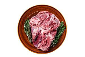 Raw Boneless Lamb leg meat in rustic plate with thyme. Isolated on white background. photo