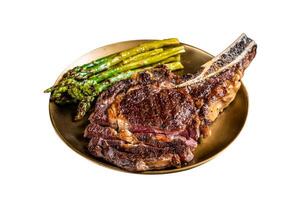 Sliced Grilled Cowboy or rib eye with bone beef steak, roasted asparagus in a plate. Isolated on white background. Top view. photo