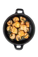Scallops seared in garlic, thyme and butter served in cast iron skillet. Isolated, white background. photo