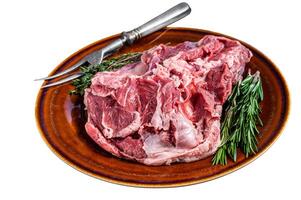 Raw Boneless Lamb leg meat in rustic plate with thyme. Isolated on white background. photo