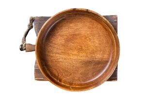 Table setting with vintage empty wooden plate on rustic wood. Isolated, white background. photo