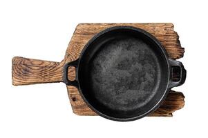 Cooking background with Empty cast-iron skillet on rustic towel. Isolated, white background. photo