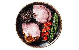 Smoked pork meat - gammon with herbs on rustic plate. Isolated, white background. Top view. photo