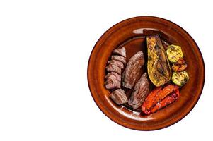 Grilled mutton tenderloin Fillet Meat, lamb sirloin on rustic plate with vegetables. High quality Isolate, white background. photo
