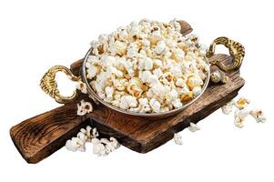 Prepared salty popcorn in a skillet and corn kernel. Isolated, white background. photo