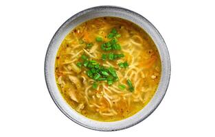 Fresh homemade chicken soup with noodle at table. Isolated on white background. photo