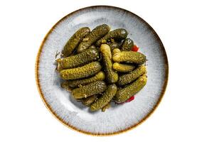 Plate with Pickled gherkins cucumbers on wooden board. High quality Isolate, white background. photo