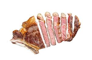 Ribeye steak on the bone with salt and pepper. Grilled Beef meat. Isolated on white background. Top view. photo