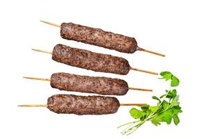 Grilled shish kebab, arabic kofta kofte kebab from mince lamb and beef meat on Skewer. Isolated, white background. photo