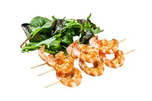 roasted shrimps, prawns on skewers with spinach salad. Isolated on white background. Top view. photo