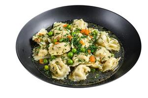 Dumplings Soup with Ravioli pasta in a bowl with greens. High quality Isolate, white background. photo