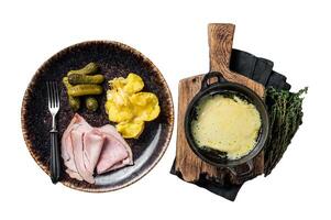 Raclette Melted cheese with boiled potato and ham on rustic plate, swiss meal. Isolated on white background. photo