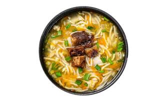 Chicken soup with noodles and vegetables. Isolated, white background. Top view. photo