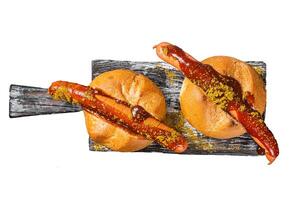 Deutsche Bockwurst sausage in a bun with French fries and curry sauce, currywurst. Isolated, white background. photo