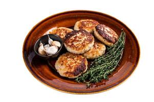 Fried pork and beef meat cutlets or patty in a rustic plate. Isolated on white background. photo