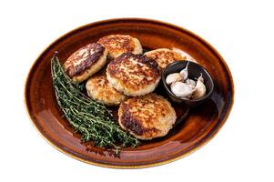 Fried pork and beef meat cutlets or patty in a rustic plate. Isolated on white background, top view. photo