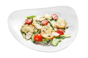 Caesar salad with grilled chicken, croutons, quail eggs and cherry tomatoes. Isolated on white background. Top view. photo