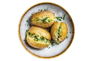 Baked Jacket potatoes with cheese and butter. Isolated on white background. photo