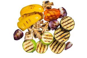 Seasonal summer Grilled vegetables on a grill, bell pepper, zucchini, eggplant, onion and tomato. Isolated on white background. photo