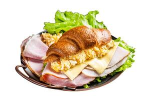 Breakfast croissant sandwich with scrambled eggs, cheese and ham. Isolated on white background. Top view. photo