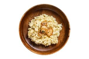 Italian Risotto with Scallops in a pan. Isolated, white background. Top view. photo