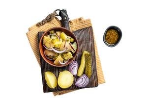 Cooking Traditional German potato salad - Kartoffelsalat. Isolated, white background. photo