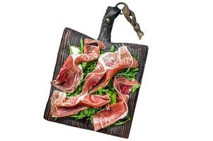 Sliced Spanish Jamon Serrano ham or Prosciutto Crudo Parma ham. Isolated on white background, Top view. photo