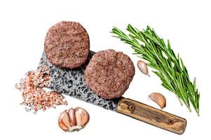Butcher beef meat steak patties on a cleaver. Isolated on white background, top view. photo