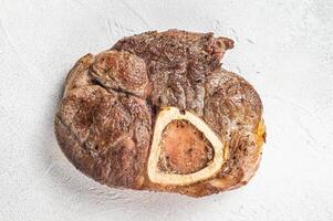 Veal shank Osso Buco, italian ossobuco meat steak. White background. Top view. Copy space photo