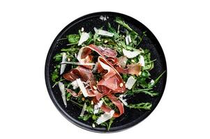 Salad with Parma, prosciutto ham, arugula and Parmesan. Isolated on white background. photo