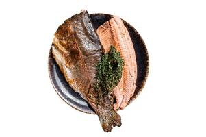 Trout roasted fillet, grilled fish on a plate with thyme and lemon. Isolated on white background. photo