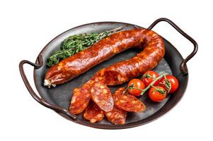 Sliced Chorizo sausage, slices of dry cured pork with herbs and spices. Isolated on white background. Top view. photo