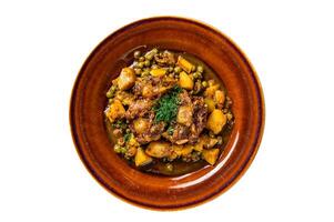 Beef veal oxtails stew with vegetables in a rustic plate. Isolated, white background. Top view. photo