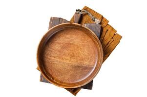 Table setting with vintage empty wooden plate on rustic wood. Isolated, white background. photo
