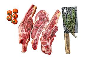 Assortment of raw cuts beef meat steaks on the bone. Black background. Top view photo