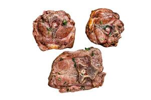 Fried lamb neck meat steaks in a wooden plate with herbs. Isolated on white background, top view. photo